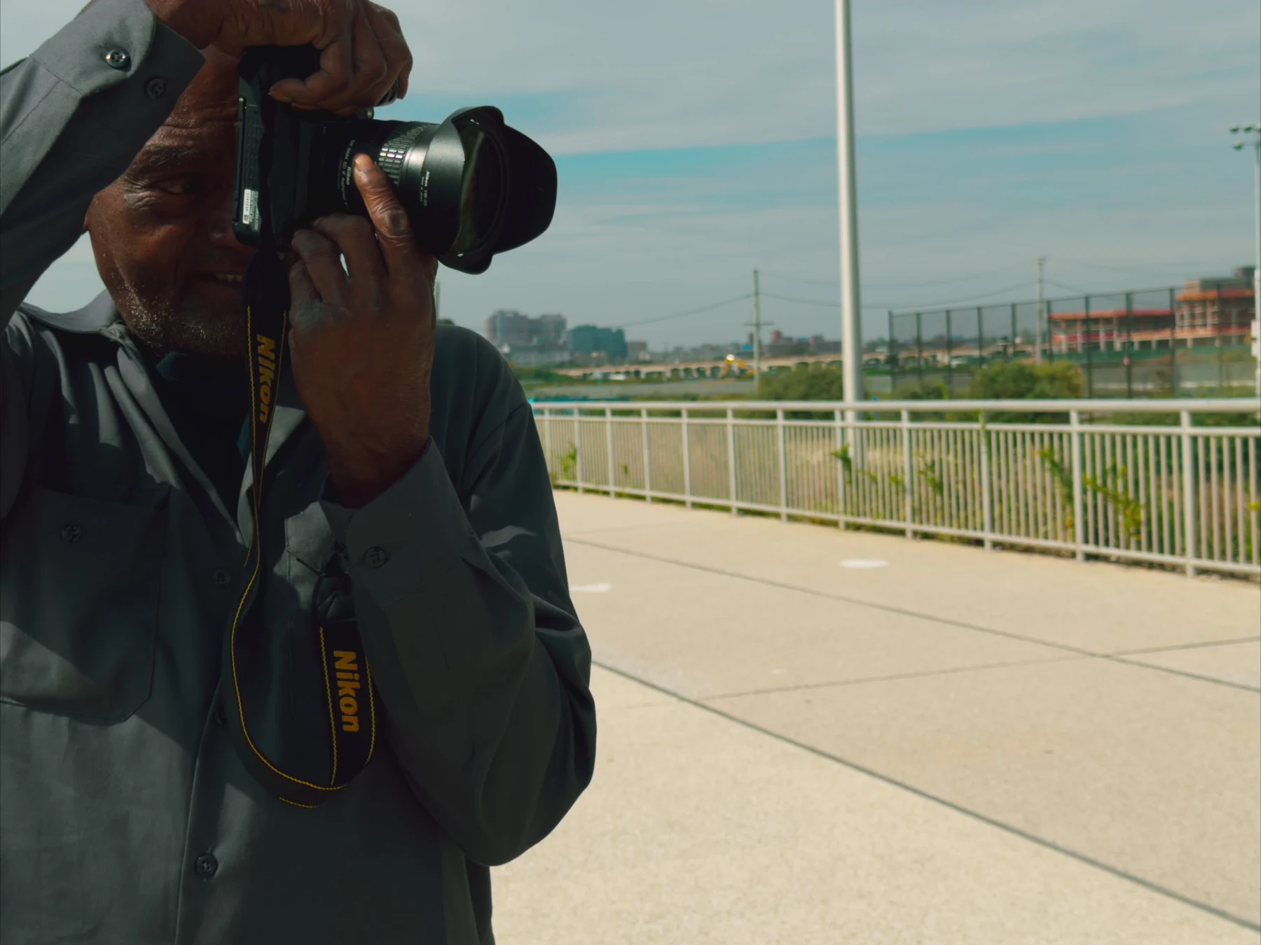 Kenny Harris photographing outdoors with his Nikon camera